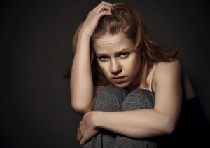 woman in depression and despair crying on black dark